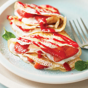 Strawberries and Cream Crepes with Raspberry Sauce